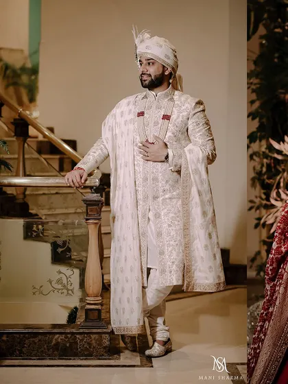 A stylish portrait of the groom, Ankit, in his ivory sherwani.