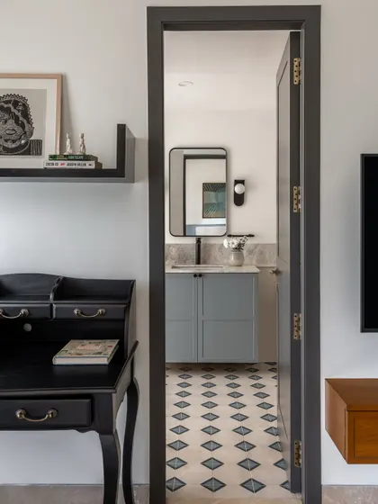 A peek into one of the bathrooms from a bedroom, showing how we carry design elements like patterned tiles and color palettes through to create a cohesive feel across private spaces.