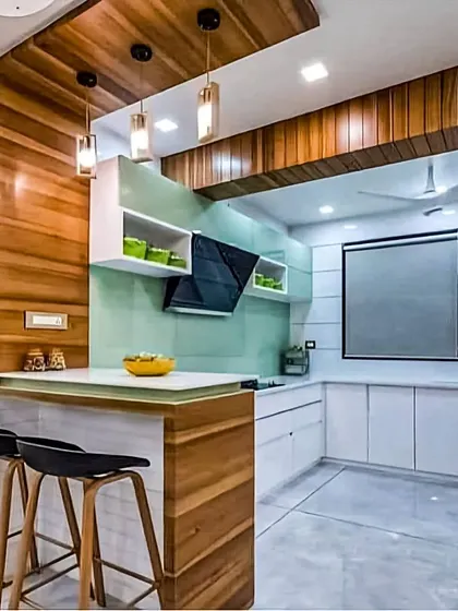 I mixed materials in this kitchen, using a wood-paneled ceiling and island base with clean white cabinets and a mint green backsplash. The result is a unique, contemporary space with a natural and refreshing feel.
