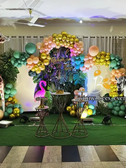 We went all out for this jungle-themed birthday party. The setup includes a lush green backdrop, life-sized animal props like a giraffe, elephant, and lion, and themed balloon arrangements to create a wild safari adventure.