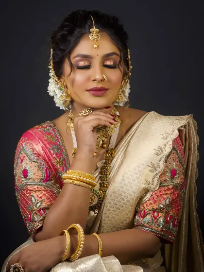 A close-up of the South Indian bridal makeup, with a focus on the soft, blended eyeshadow and the perfectly defined lips.