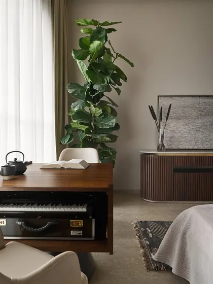 A detailed shot of the custom harmonium table in the Lumen House master bedroom. The design provides dedicated storage for the instrument while doubling as a functional study table, blending personal hobbies with everyday life.