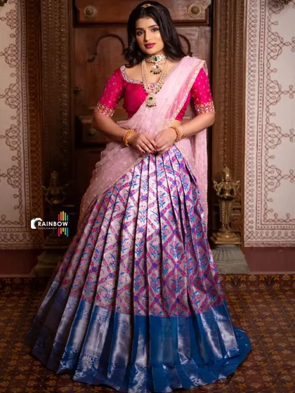 A full-length shot of the model, providing a clear view of the entire pink and blue Langa Voni ensemble.