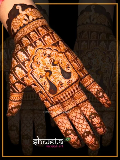 A close-up view of a detailed peacock design on the back of the hand. Notice the fine lines in the feathers and the clean execution of the jaali (net) pattern.