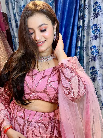 A smiling shot of the model in the pink sequin lehenga, showing how confident and happy you can feel in the right outfit.
