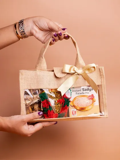 Presenting the 'Kaithola' hamper, a simple yet elegant gift in a traditional jute bag. It's perfect for sharing Onam's essential flavors, like the included instant sadya palada mix.