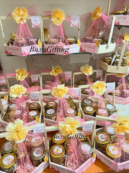 A display of the finished Haldi hampers, each topped with a flower and ready to be gifted to guests.