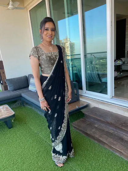 The full look, set against a beautiful balcony view. The makeup is sophisticated and chic, perfect for an evening event.