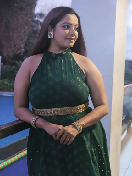 Another angle of my green fusion dress. The halter-neck design and gold belt create a stylish silhouette that is both comfortable for a long event and chic for a corporate setting.