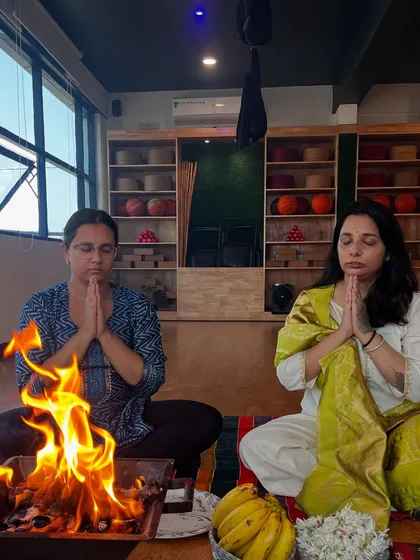 Two of our lead instructors in prayer during the Havan Puja for the new TTC batch, setting a sacred intention for the course ahead.