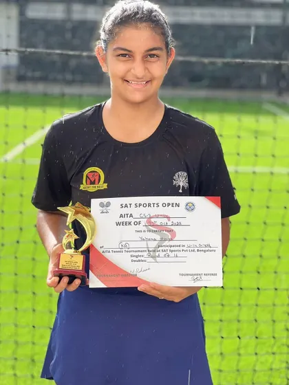A solo shot of Yahana with her U/14 CS doubles finalist trophy.