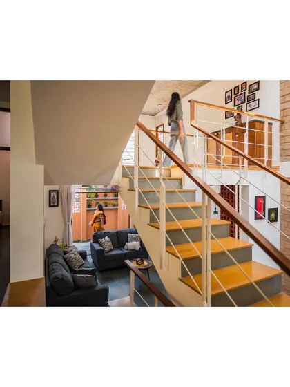 A view of the staircase in the Kaustubha Residence, showing how different living spaces are connected across levels. The open design maintains a sense of spaciousness and flow.
