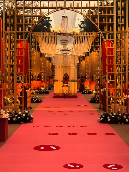 We designed this grand entrance for a sacred Ganesh Puja, creating a pathway of light and devotion. Hundreds of candles within golden arches and a vibrant red carpet guide guests toward the ceremony, creating a powerful sense of arrival and reverence.