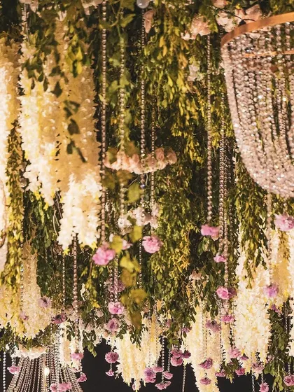 Another detail of the hanging floral garden. Cascading crystal beads are interwoven with fresh greenery and delicate pink and white flowers, creating a design that feels both glamorous and organic.