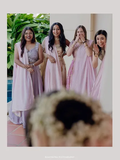 The bridesmaids' priceless reactions as they see the bride for the first time, captured from the bride's point of view.