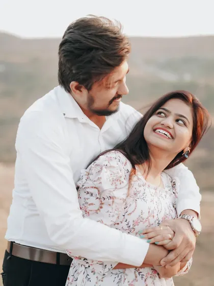 A joyful embrace with a genuine smile. This is the kind of heartwarming, candid photography I love to create.