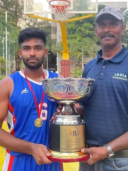 With my coach, holding the FR Rebello Memorial Cup after our victory. A proud moment for the team.