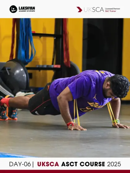 A participant executes a resistance band push-up, a variation used to assess upper body strength and stability on Day 6.