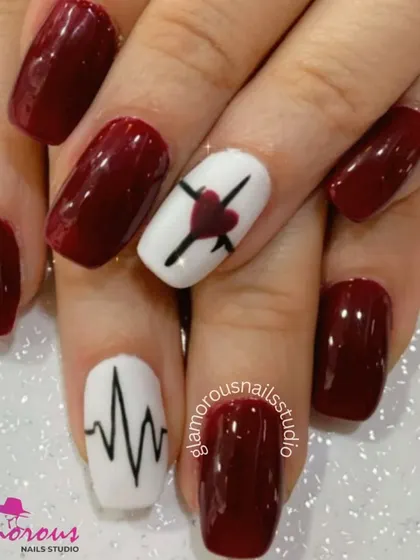 A bold and edgy design with deep red nails and white accent nails featuring a heartbeat line and a crossed-out heart.
