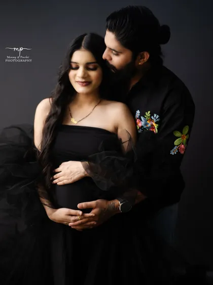 A modern and intimate portrait for the contemporary couple. The simplicity of the black-on-black styling creates a powerful and chic look, focusing entirely on the connection and the beautiful baby bump.