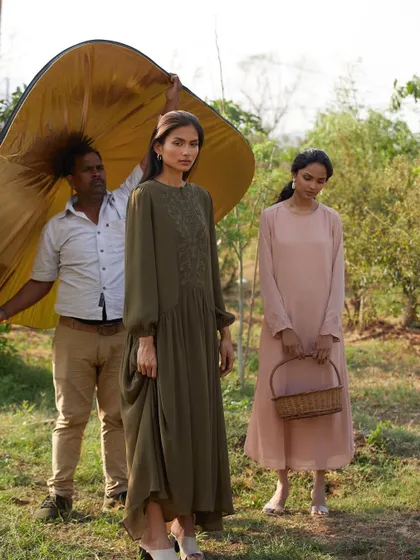 A look at how we control and shape natural light even when outdoors. Here, an assistant is using a large reflector to bounce warm, golden light onto the models, creating a soft and flattering glow.