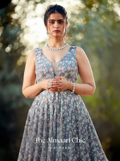 This floral embroidered gown offers a touch of whimsical romance. The A-line cut and delicate pattern make it a beautiful choice for a garden party or a summer evening event.