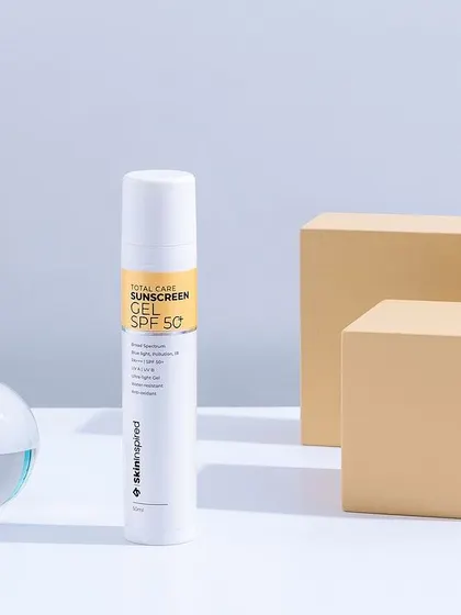 A clean, minimalist shot for a sunscreen product. The neutral color palette and simple geometric props give the image a scientific and trustworthy feel, focusing on the product's efficacy.