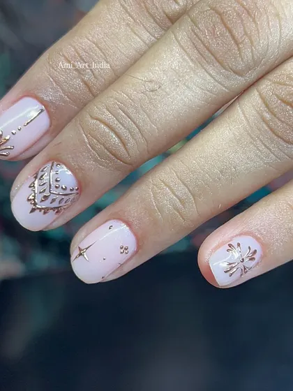 This design uses gold chrome stamping to create intricate, traditional patterns on a soft pink base.