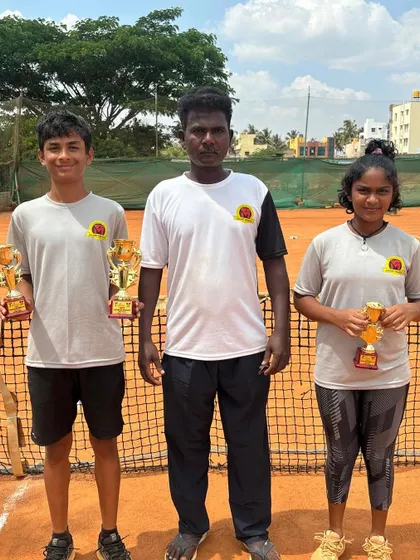 Our coach stands proudly with Svar and Eshita, showcasing the success of our junior program.