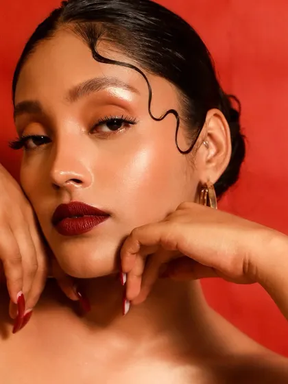 For those who love a bold statement, this look channels timeless Hollywood glamour. A classic, deep red lip paired with clean, radiant skin and sharp winged liner creates an unforgettable and confident style.