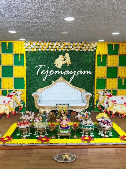 A simple yet elegant baby shower setup with a Krishna-themed backdrop, showing that beauty lies in thoughtful curation, not just quantity.