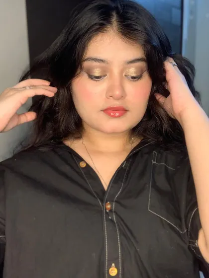A soft, golden-hour makeup look with shimmery gold eyeshadow.