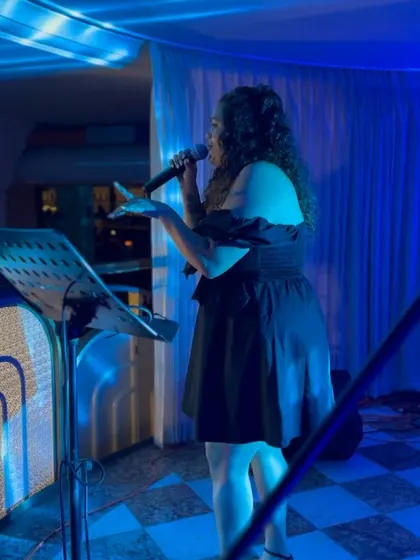 A side view of our live performer, showing the intimate connection she builds with the audience throughout her set.