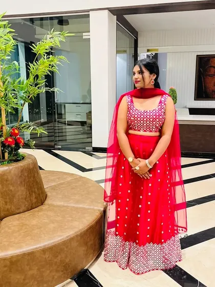 This bright pink and silver lehenga is a fun and festive option for any celebration. It's lightweight and easy to wear, making it a great rental for a sangeet or party.