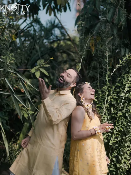 A fun and candid back-to-back portrait of the couple laughing during their Haldi ceremony. We believe in capturing the joy and playfulness of your relationship.