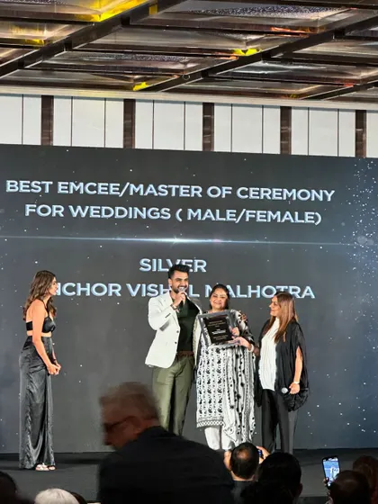 A side view of the award presentation, capturing the photographers and the audience. It was a night to remember.
