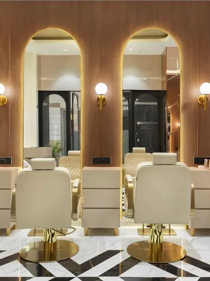 The styling stations at the makeup studio, with custom-designed chairs, arched mirrors, and integrated lighting, all designed to be both highly functional and aesthetically beautiful.