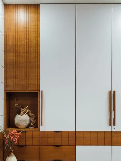 This wardrobe combines white doors with warm wood-paneled sections and drawers. The open niche is perfect for displaying a vase or other decorative items, adding a personal touch.