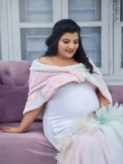 A close-up of our rainbow pastel gown. The soft, fuzzy shawl adds a cozy and sweet touch, perfect for a winter-themed or indoor shoot.