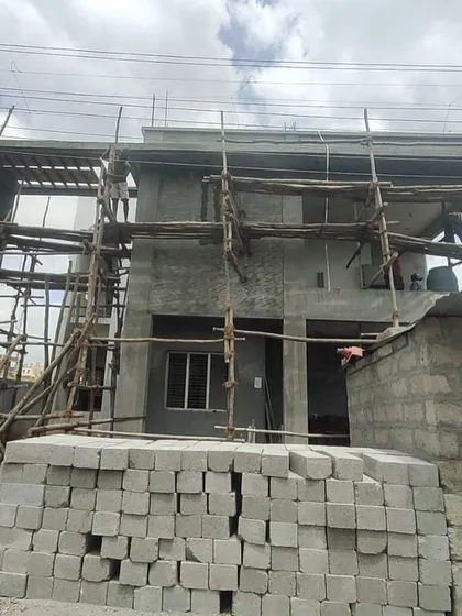 An identical photo of the house under construction, showing the vision taking shape.