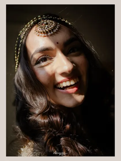 A close-up of the bride's happy, sun-kissed face. The natural light brings out her beautiful smile.