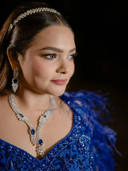 A close-up portrait of the bride, showcasing her stunning jewelry and makeup for the Sangeet night. Her elegant and confident look is captured beautifully.