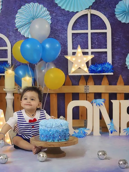 A classic blue and white theme for a handsome little man. He looks so excited to start his cake smash celebration.