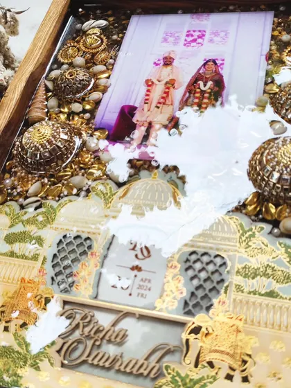 My first-ever preservation of kaleras in a wooden frame. This piece combines the wedding card, kaleras, varmala flowers, and special shells into one grand memory.
