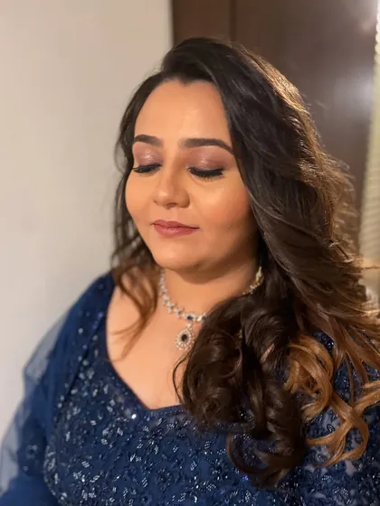 A close-up of Anisha's eye makeup, featuring a soft pink shimmer on the lids and defined eyeliner.