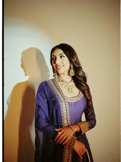 A regal and elegant look created for the "Heeramandi" premiere. The makeup is soft and timeless, with defined eyes and glowing skin, paired with a royal purple Anarkali.