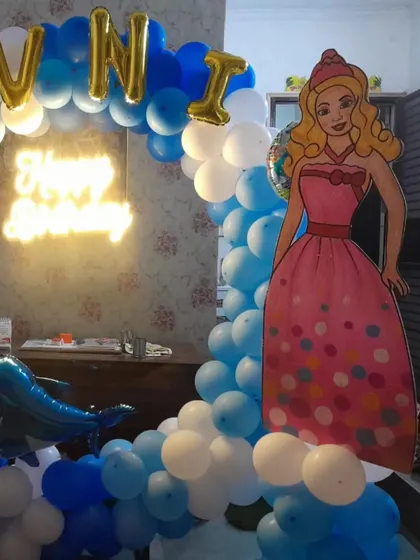 A close-up of the princess-themed balloon arch, showing the detail of the balloon arrangement and the placement of the character cutout.