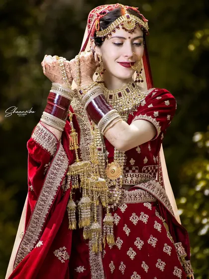 A beautiful, happy portrait of the bride, capturing a moment of pure joy as she adjusts her earrings.