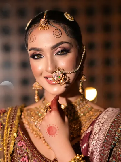 The bride's happy smile and sparkling eyes are the focus of this portrait. The makeup is both regal and approachable, perfect for a modern queen.