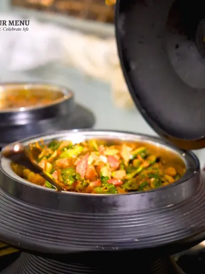 A close-up of a Chinese dish in an elegant black serving bowl, part of our beautifully designed Pan-Asian counter.